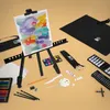 An art set laid out on a light beige surface, featuring a small easel with a painting, various art supplies like paints, brushes, pencils, and paper. Produktbild-Vorschau