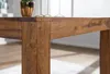 A close-up view of the corner of a wooden table, showing the joinery and wood grain. Náhled obrázku produktu