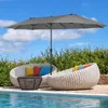 Two white woven lounge chairs with colorful cushions are placed next to a swimming pool, under a large gray double umbrella. Podgląd zdjęcia produktu
