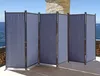 A gray, multi-panel room divider is set up on a patio overlooking the ocean. Produktbild-Vorschau