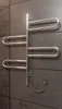 A heated towel rack mounted on a tiled wall. Podgląd zdjęcia produktu