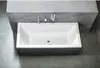 A modern rectangular bathtub with a dark gray exterior and white interior, set against a concrete-like wall and floor. Náhled obrázku produktu