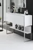 A white console table with silver legs and shelves, decorated with vases and a framed picture. Anteprima dell’immagine prodotto