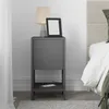 A modern nightstand with a lamp and e-reader on top, placed next to a bed. Anteprima dell’immagine prodotto