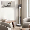 A collage showing a cordless vacuum cleaner being used on a couch and a vacuum cleaner standing in a modern living room. Anteprima dell’immagine prodotto