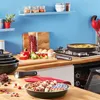 A kitchen counter with cookware, ingredients, and an oven. Voir les images du produit