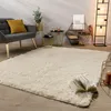 A living room scene with a rug, chair, side tables, and a floor lamp. Produktbild-Vorschau