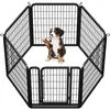 A puppy sits inside a black metal octagon-shaped playpen. Podgląd zdjęcia produktu