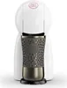 A white Nescafe Dolce Gusto coffee machine with a patterned gray and bronze mug. Produktbild-Vorschau