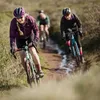 Three people riding bicycles on a dirt path. Produktbild-Vorschau