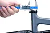 A hand is holding a digital caliper and measuring a bicycle part. Produktbild-Vorschau