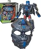 A Transformers Optimus Primal 2-in-1 figure and mask set is displayed against a white background. The packaging is to the left, showing the mask and a smaller figure. The larger figure is in the center, and the mask is in the foreground. Produktbild-Vorschau