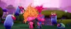 A colorful, cartoonish scene with two pink troll characters and various whimsical creatures in a vibrant, alien-like landscape. Produktbild-Vorschau