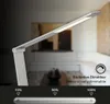 A desk lamp is shown in a dimly lit room with a sofa in the background. A slider with brightness percentages is displayed at the bottom. Produktbild-Vorschau