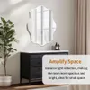 A decorative mirror is displayed above a dresser in a room setting. Anteprima dell’immagine prodotto