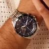 A close-up shot of a man's wrist wearing a silver Casio Edifice watch with a blue dial. Produktbild-Vorschau