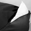 A close-up view of a black dog bed with a white pillow peeking out from an open zipper. Anteprima dell’immagine prodotto