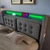 A close-up view of a modern upholstered bed with a built-in LED headboard and charging station. Anteprima dell’immagine prodotto