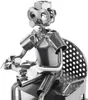 A close-up shot of a metal figurine of a gamer sitting and holding a controller. Náhled obrázku produktu
