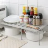 A kitchen shelf organizer holding various bottles and bowls on a countertop. Podgląd zdjęcia produktu