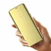 A hand holding a gold smartphone case with a clear view flip cover. Produktbild-Vorschau