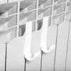 Two white hooks attached to a radiator. Podgląd zdjęcia produktu