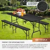 A black picnic table and bench set is set up on a green lawn in a garden, with a cake and plates on the table. Náhľad obrázku produktu