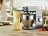 A kitchen scene with a stand mixer making pasta. Produktbild-Vorschau