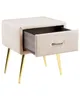 A beige velvet nightstand with an open drawer and gold metal legs, shown against a white background. Náhľad obrázku produktu