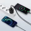 Two smartphones are charging from a power strip using a black charger. Produktbild-Vorschau