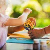 A child and an adult are doing arts and crafts with scissors and colored paper. Voir les images du produit