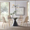 A dining room scene with a round table and four chairs, a chandelier, and a framed map on the wall. Náhľad obrázku produktu