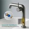 A cutaway view of a faucet, showing its internal components, placed on a sink. Podgląd zdjęcia produktu