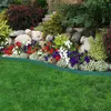A garden bed with a variety of flowers and plants, bordered by a green plastic edging and a lawn. Náhled obrázku produktu