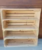 A wooden shelving unit made of stacked crates against a wooden wall. Náhled obrázku produktu
