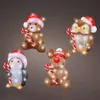 Four illuminated Christmas figures: a bear, an owl, a penguin, and a reindeer, each holding a candy cane and wearing a Santa hat. Voir les images du produit
