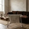 A drying rack with towels is placed in a living room setting, in front of a sofa. Produktbild-Vorschau
