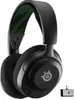 A black SteelSeries Arctis Nova 5x headset with a green patterned headband, shown against a white background. A small USB dongle is visible to the right of the headset. Produktbild-Vorschau