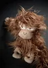 A stuffed monkey toy with shaggy brown fur and a neutral expression against a dark background. Náhled obrázku produktu