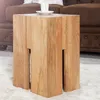 A wooden side table with a cup and saucer on top, placed on a rug next to a brown sofa. Produktbild-Vorschau