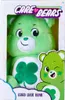 A green Care Bear plush toy named Good Luck Bear is shown in its packaging. Produktbild-Vorschau