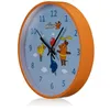 A close-up, angled view of a children's wall clock with an orange frame and a light blue face featuring cartoon characters. Voir les images du produit