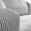 Close-up of the textured fabric of a sofa armrest and cushions. Produktbild-Vorschau