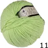 A ball of light green yarn with a label showing product information. Podgląd zdjęcia produktu