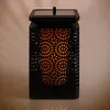 A black solar lantern with a flame effect. Podgląd zdjęcia produktu