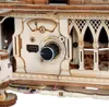 A close-up view of a wooden gramophone model, focusing on the control panel with a dial and a meter. Podgląd zdjęcia produktu