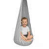 A young child sits happily in a hanging chair. Náhled obrázku produktu