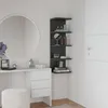 A corner shelf unit with decorative items and books, next to a vanity table with a mirror and stool. Produktbild-Vorschau
