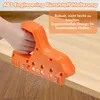 A hand is holding an orange edge banding trimmer tool on a wooden surface. Produktbild-Vorschau