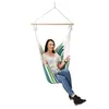 A woman sits in a striped hammock chair. Náhled obrázku produktu
